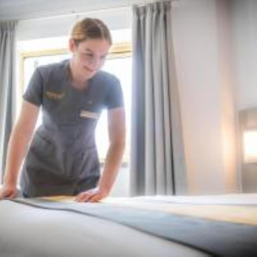 Maldron Hotel Glasgow City Exterior photo A maid in a luxury hotel.